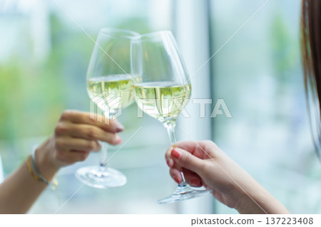 Couple holding glasses toasting Couple holding glasses toasting 137223408