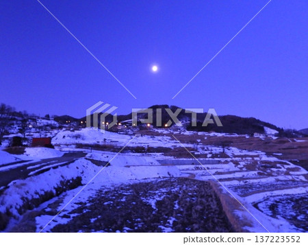 The setting snow moon and the Obasute rice terraces the morning after the beginning of spring 137223552