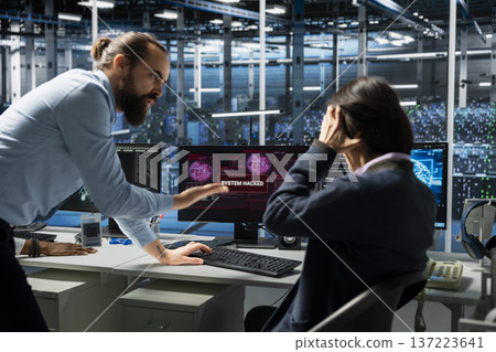 Angry manager berating engineer in server hub for letting hacker steal sensitive company data. Mad data center team leader scolding worker for not stopping computer virus to breach security systems 137223641