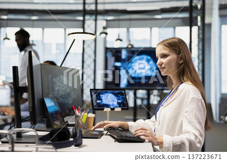 Young tech startup admin in office integrating AI machine learning systems to streamline workflows. Female programmer uses neural networks artificial intelligence, technology overload concept Young tech startup admin in office integrating AI machine learning systems to streamline workflows. Female programmer uses neural networks artificial intelligence, technology overload concept 137223671