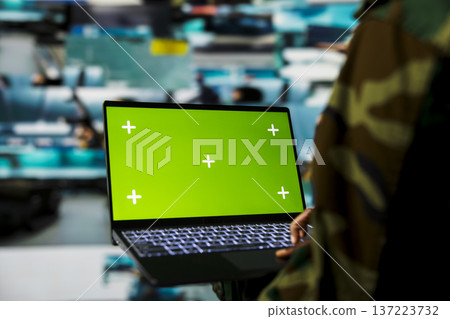 Green screen mockup laptop used by army officer using reconnaissance tech to do threat monitoring and target recognition. Woman employing warfare intelligence using chroma key notebook software Green screen mockup laptop used by army officer using reconnaissance tech to do threat monitoring and target recognition. Woman employing warfare intelligence using chroma key notebook software 137223732