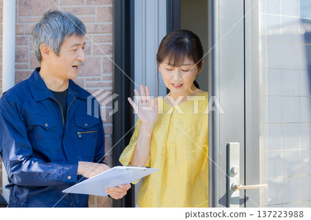 A man in work clothes explaining at the entrance 137223988