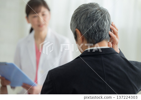 Doctor examining a senior man Doctor examining a senior man 137224303