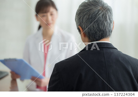 Doctor examining a senior man Doctor examining a senior man 137224304