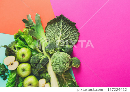 Green vegetables and fruits. Diet, detox and healthy food concept - top view flat lay of vegetarian meals on bright background. Ingredients for salad Green vegetables and fruits. Diet, detox and healthy food concept - top view flat lay of vegetarian meals on bright background. Ingredients for salad 137224412