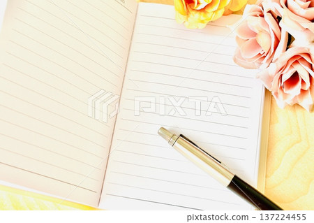 Notebook and dried flowers on the desk Notebook and dried flowers on the desk 137224455