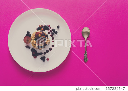 Healthy breakfast, dieting and detox concept - wholegrain fresh oatmeal porridge on plate with fruits, berries and nuts on pink background, top view, copy space Healthy breakfast, dieting and detox concept - wholegrain fresh oatmeal porridge on plate with fruits, berries and nuts on pink background, top view, copy space 137224547