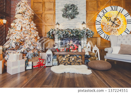 Beautiful christmas interior. Warm room with fireplace, decorated christmas tree, lots of presents and huge clock on wooden wall. Cozy home for winter holidays, copy space Beautiful christmas interior. Warm room with fireplace, decorated christmas tree, lots of presents and huge clock on wooden wall. Cozy home for winter holidays, copy space 137224551