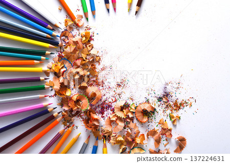 Drawing tools background. Lot of colorful pencils frame with sawdust and shavings on white, copy space, flat lay Drawing tools background. Lot of colorful pencils frame with sawdust and shavings on white, copy space, flat lay 137224631