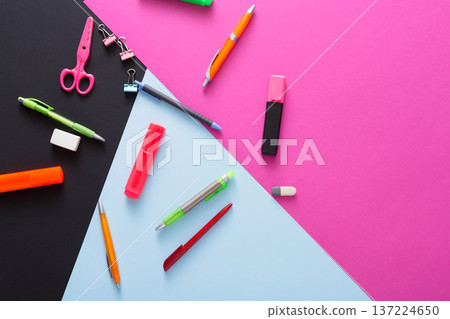 Bright stationery items including pens, markers, scissors, and sticky notes are arranged on a colorful backdrop. This setup showcases a playful and artistic workspace, ideal for creativity. Bright stationery items including pens, markers, scissors, and sticky notes are arranged on a colorful backdrop. This setup showcases a playful and artistic workspace, ideal for creativity. 137224650