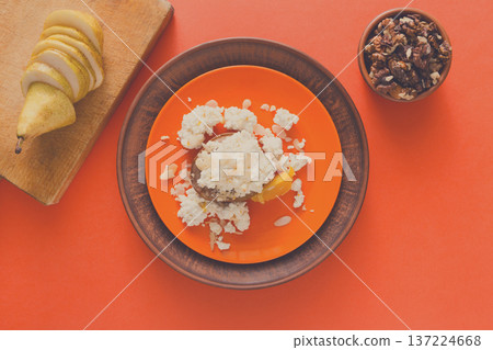 Healthy breakfast, dieting and detox concept - fresh cottage cheese on plate, bowl with nuts and wood board with fruit on bright background. Still life, flat lay, top view, copy space Healthy breakfast, dieting and detox concept - fresh cottage cheese on plate, bowl with nuts and wood board with fruit on bright background. Still life, flat lay, top view, copy space 137224668