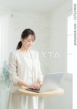 Woman using a laptop Woman using a laptop 137224692