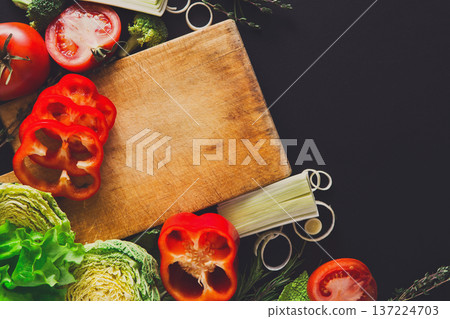 Cooking healthy food background. Fresh organic vegetables on black. Natural food with copy space. Cooking healthy food background. Fresh organic vegetables on black. Natural food with copy space. 137224703