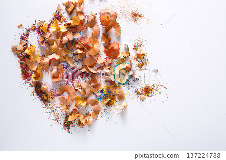 Wooden colored pencil sharpening shavings pile on white isolated background, top view, flat lay, copy space Wooden colored pencil sharpening shavings pile on white isolated background, top view, flat lay, copy space 137224788