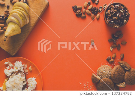 Healthy breakfast, dieting and detox concept - fresh cottage cheese on plate, bowl with nuts and wood board with fruit on bright background. Still life, flat lay, top view, copy space 137224792
