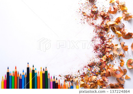 Drawing tools background. Lot of colorful pencils frame with sawdust and shavings on white, copy space, flat lay Drawing tools background. Lot of colorful pencils frame with sawdust and shavings on white, copy space, flat lay 137224864