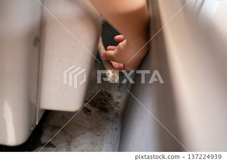 Drainage from the drain hose of the outdoor unit of an air conditioner installed on a veranda or balcony 137224939