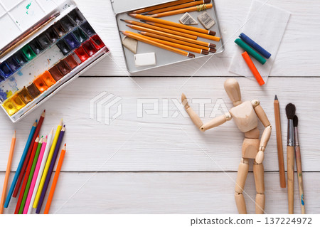 Drawing tools, stationary supplies, workplace of artist. Paints and wooden painter man with brushes on white desk, top view, flat lay, objects Drawing tools, stationary supplies, workplace of artist. Paints and wooden painter man with brushes on white desk, top view, flat lay, objects 137224972