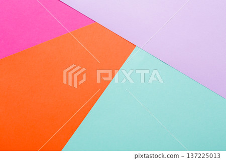 Vibrant colored paper shapes in pink, orange, purple, and turquoise are arranged in a geometric pattern on a flat surface. The composition showcases a playful and artistic design. Vibrant colored paper shapes in pink, orange, purple, and turquoise are arranged in a geometric pattern on a flat surface. The composition showcases a playful and artistic design. 137225013