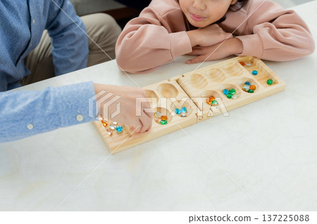 Family playing board games in the living room Family playing board games in the living room 137225088