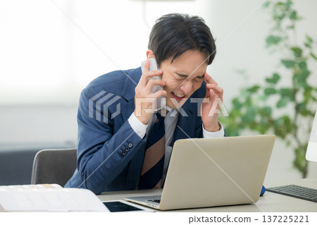 A serious looking businessman A serious looking businessman 137225221