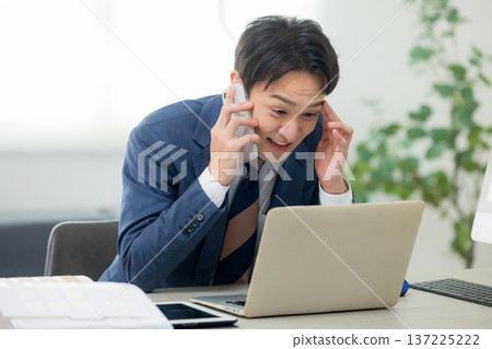 A serious looking businessman A serious looking businessman 137225222