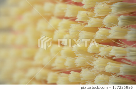 Abstract macro shot of dense yellow synthetic bristles with shallow depth of field Abstract macro shot of dense yellow synthetic bristles with shallow depth of field 137225986