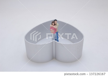 Miniature Pair Stands Together Within Heart Shaped Frame Miniature Pair Stands Together Within Heart Shaped Frame 137226167