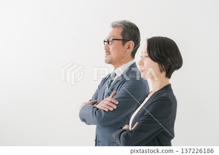 A middle-aged business person with his arms crossed A middle-aged business person with his arms crossed 137226186