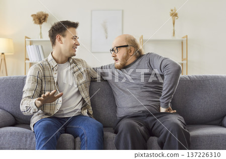 Cheerful Son And Senior Father Conversing At Home 137226310