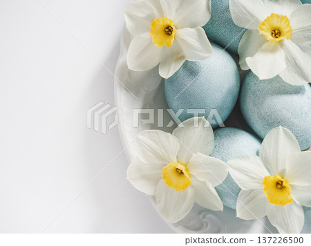 Pastel blue Easter eggs on a white table 137226500