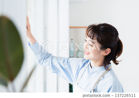 Woman cleaning the window Woman cleaning the window 137226511