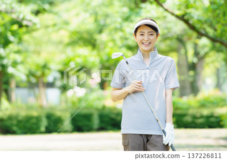 Middle-aged woman playing golf Middle-aged woman playing golf 137226811