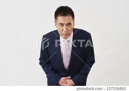 Senior businessman bowing his head, apology, white background Senior businessman bowing his head, apology, white background 137226893