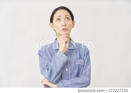 Woman in pajamas thinking white background 137227230