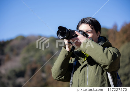 Men taking pictures in the mountains 137227270