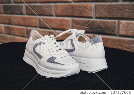 Fresh beige leather sneakers without brand marks displayed. For design templates online shops and sustainability-themed marketing. Clean blank sneakers 137227606
