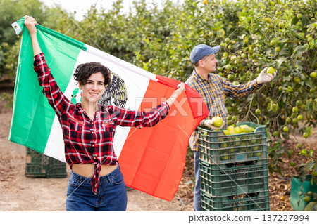 Positive woman holding Mexico flag in fruit plantation 137227994