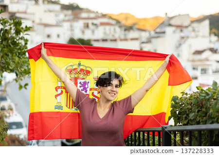 latin adult woman holding a Spanish flag 137228333