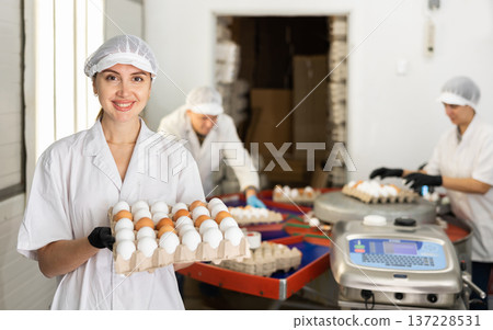 Woman holding carton tray with fresh eggs on farm Woman holding carton tray with fresh eggs on farm 137228531