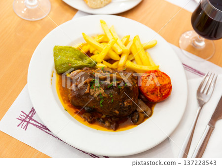 Liver meat with mushrooms, french fries and vegetables 137228543