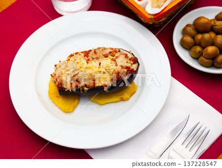 Eggplant stuffed with baked vegetables in sauce and baked cheese 137228547