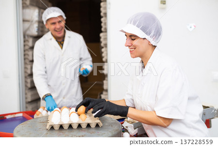Chicken farm female employee sorts and labels chicken eggs Chicken farm female employee sorts and labels chicken eggs 137228559