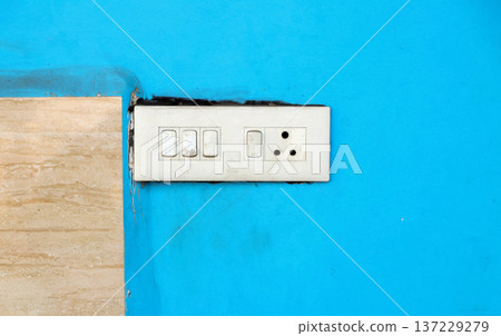White Electric Switchboard on Blue Wall 137229279