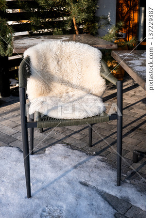 Outdoor Chair With Sheepskin Cover On Winter Patio Terrace 137229387
