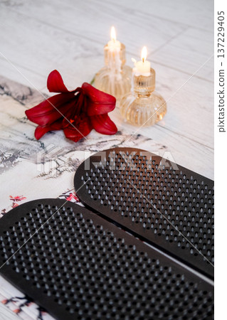 Sadhu board. Yoga tool. Sharp nails for practice calming meditation training foot massage developing spiritual growth flower candles placed on floor. Sadhu board. Yoga tool. Sharp nails for practice calming meditation training foot massage developing spiritual growth flower candles placed on floor. 137229405