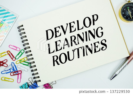 Develop Learning Routines text message written on notepad with stationery flat lay on white background 137229530