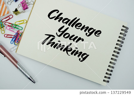 Challenge Your Thinking text message written on notepad with stationery flat lay on white background Challenge Your Thinking text message written on notepad with stationery flat lay on white background 137229549