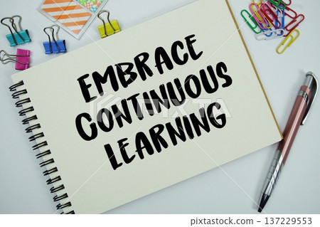 Embrace Continuous Learning text message written on notepad with stationery flat lay on white background Embrace Continuous Learning text message written on notepad with stationery flat lay on white background 137229553