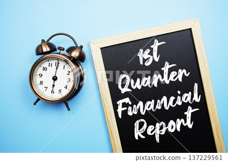 1st Quarter Financial Report text on Blackboard and alarm clock on blue background 1st Quarter Financial Report text on Blackboard and alarm clock on blue background 137229561